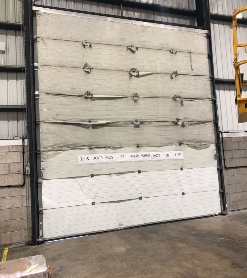 Sectional High Rise Door has been impacted -1